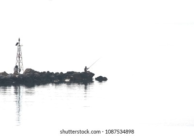 Silhouette of fisherman with fishing rods and lighthouse on the pier. Minimalism.  - Powered by Shutterstock