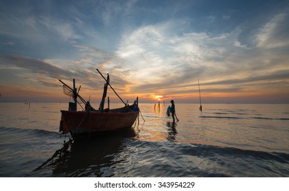 Silhouette Of Fishermen With Yellow And Orange  Sunset