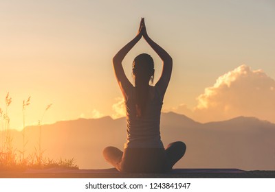 Silhouette Fitness Girl Practicing Yoga On Mountain With Sun Light