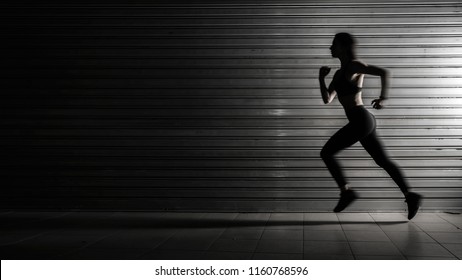 Silhouette of fitness woman running