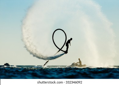Silhouette of a fly board rider at sea