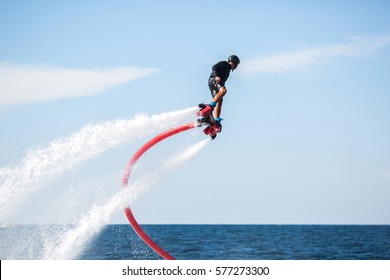 Silhouette of a fly board rider at sea