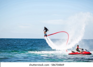 Silhouette of a fly board rider at sea
