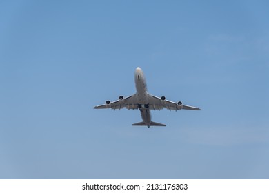 Silhouette of four engine jet taking off into the skies