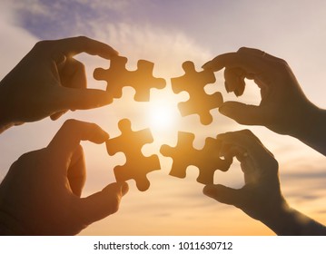 silhouette four hands trying connect puzzle stock photo edit now
