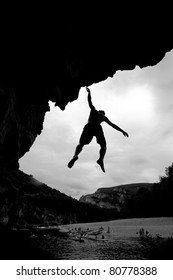 Silhouette Of Free Climber Falling In Water