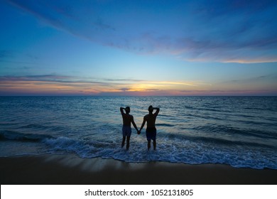 Silhouette Gay Couple Hand In Hand On The The Beach And Sunset Time