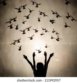 Silhouette of girl and dove, freedom and peace abstract concept background