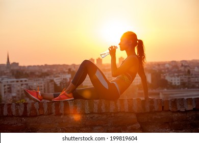 silhouette of girl drinking water outdoor - Powered by Shutterstock