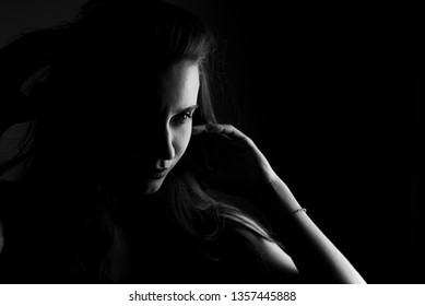 silhouette of girl face on black background in noir style