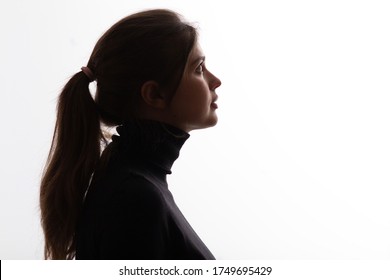 silhouette girl portrait on white isolated background, young beautiful woman profile in black clothes