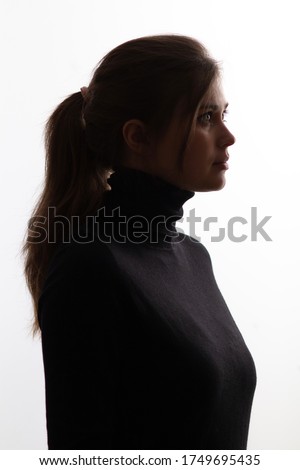 silhouette girl portrait on white isolated background, young beautiful woman profile in black clothes
