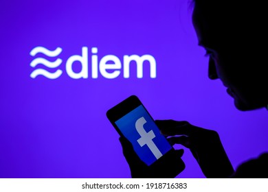 Silhouette of a girl with smartphone and Facebook Diem cryptocurrency logo on the blurred screen. Real photo, not a montage, no edit in post. Stafford, United Kingdom: February 16, 2021.