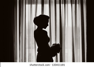 silhouette of a girl at the window