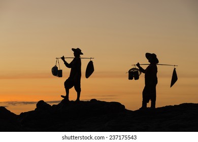 Silhouette Of Gold Panner Walking To Come Back Home With Sunset