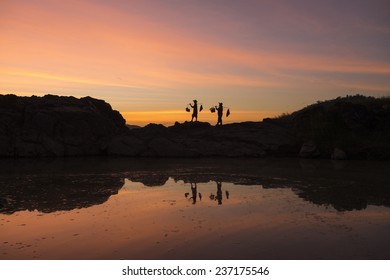 Silhouette Of Gold Panner Walking To Come Back Home With Sunset