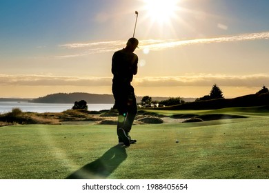 silhouette of a golfer out playing