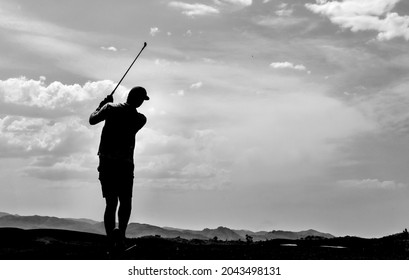 silhouette of a golfer swinging - Powered by Shutterstock