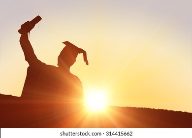 Silhouette Of Graduate Against Sun Shining