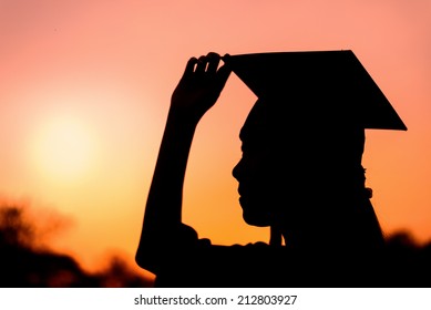 Silhouette Of Graduate Woman In Sunset