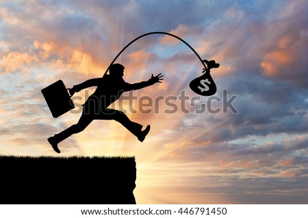 Silhouette of a greedy man running by looking at money, not noticing the abyss. Concept of greed and money