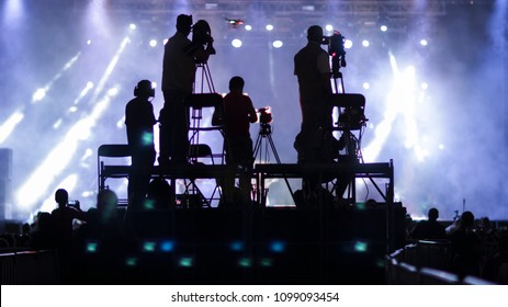 Silhouette Group Of Cameramen At An Event