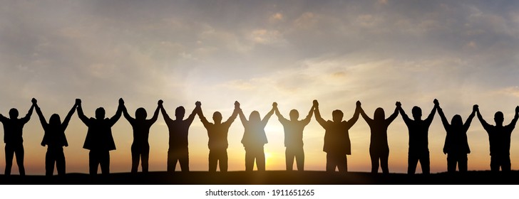 Silhouette Of Group Happy Business Team Making High Hands Over Head In Sunset Sky Background For Business Teamwork Concept.