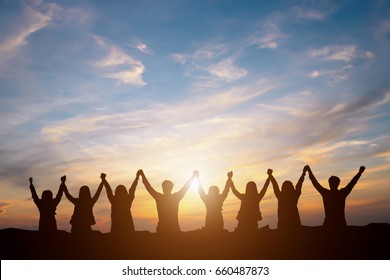 Silhouette of group happy business team making high hands over head in beautiful sunset sky evening time for business success and teamwork concept in company  - Shutterstock ID 660487873