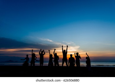 Silhouette Group Of People Jumping On The Beach At Golden Sunset Time, Hello Summer Concept