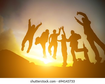 Silhouette Group People Jumping Over Sunrise Stock Photo 694143733 