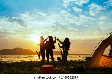 Silhouette Group Of Women Party And Dancing With Drink Bottles Enjoy Travel Camping,trekking In Vacation Time At Sunset.