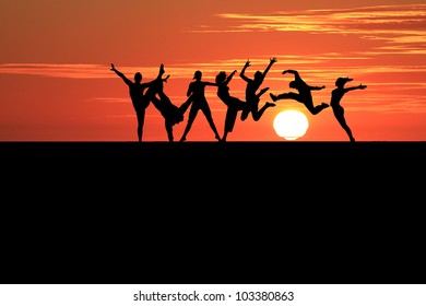 silhouette of gymnasts in sunset - Shutterstock ID 103380863
