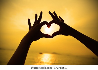 Silhouette Hand In Heart Shape During Sunset