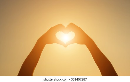 Silhouette Hand Heart Shape With Sun Light