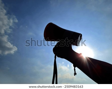silhouette of hand holding megaphone. protest concept