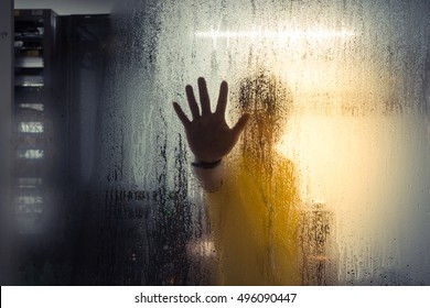 Silhouette Of Hand Of Man On Glass With Water Drop In Computer Server Mainframe Room In Data Center , Process In Vintage Style