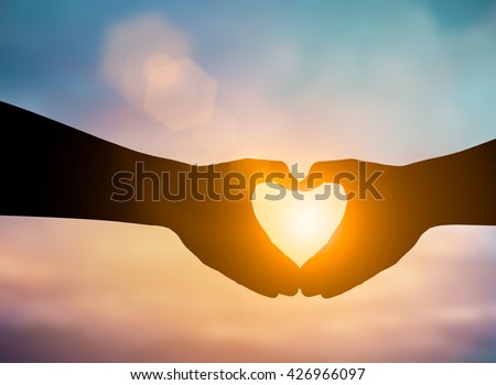 Silhouette hands making a heart shape