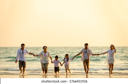 Silhouette Happy Asian Diversity Generation Family Holding Hands And Having Fun Together On Tropical Beach At Summer Sunset. Smiling Big Family Parents With Child Boy And Girl Enjoy Travel Vacation