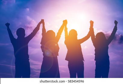 Silhouette Of Happy Business Team Making High Hands In Sunset Sky Background For Business Teamwork Concept