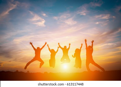 Silhouette Of Happy Business Team Making High Hands In Sunset Sky Background For Business Teamwork Concept.