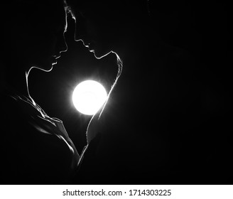 Silhouette a happy couple holding each other. Couple in love. Shadow. Man and woman posing studio. Heart. Valentine day. Lovers. Background. Men. Guy. Beauty photo. Romantic lovers. Lovely. Face.
