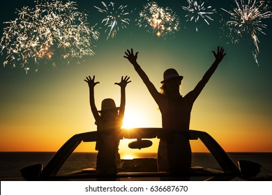 Silhouette Of Happy Family At The Beach Against Sunset Sky And Sea Background. People Traveling By Car. Summer Vacation And Travel Concept