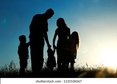 Silhouette Of A Happy Family With Children On Sunset