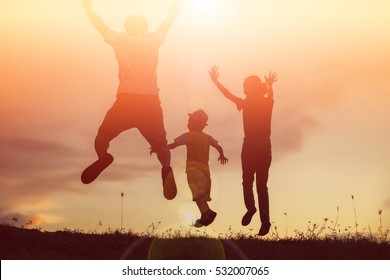 Silhouette Of A Happy Family And Happy Time Sunset