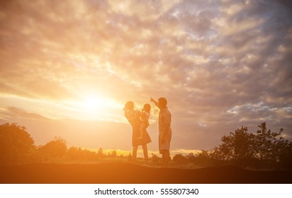 Silhouette Of A Happy Family And Happy Time Sunset