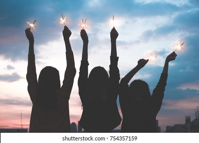 Silhouette Happy Group Of Asian Young Girl Friends Hangout Enjoy And Play Sparklers Firework At Night Rooftop New Year Party At Evening Sunset,Holiday Celebration Festive,teenage People Lifestyle