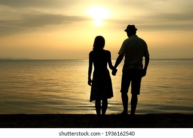 silhouette of a happy loving couple at sunset on the seashore