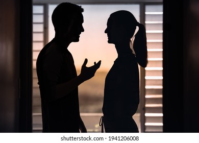 Silhouette Of Happy Man And Woman Talking Having A Good Conversation. Couple Relationships Concept. 