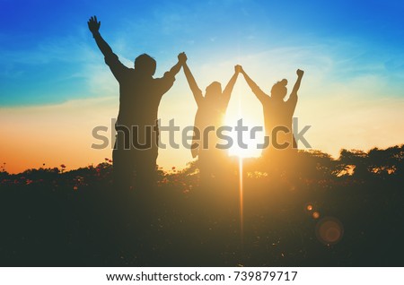 Silhouette of happy success positive teamwork hold hands up as business successful, business victory & celebrate achievement. Accomplish people merger & acquisitions concept.
