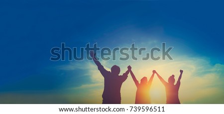 Silhouette of happy teamwork hold hands up as a business successful, business victory, achieve business goal